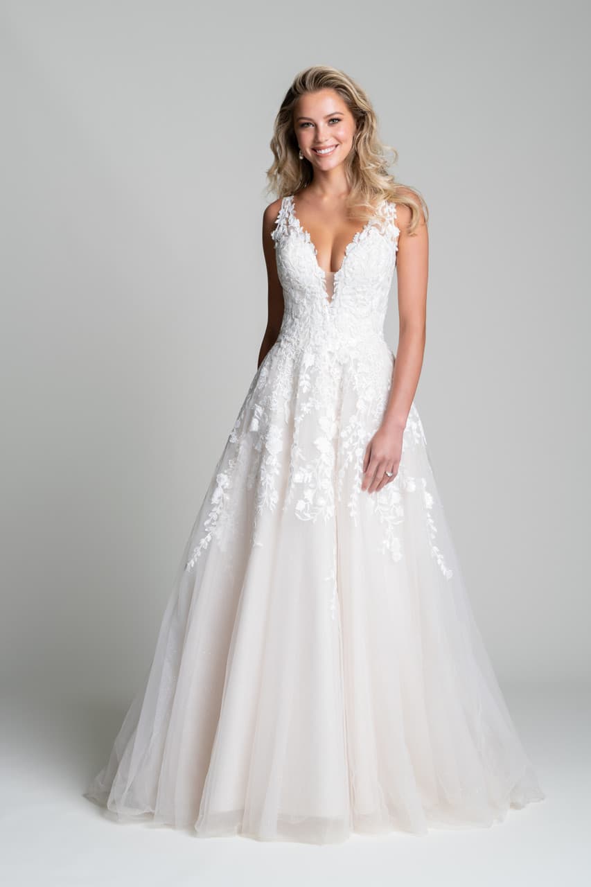 A-line wedding dress with deep V lace bodice, floral appliqué, and soft flowing skirt front view