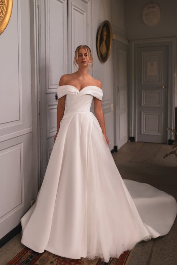 Kelly - Katy Corso wedding dress by Katy Corso The Kelly dress has an interesting cut and unusual design view 1