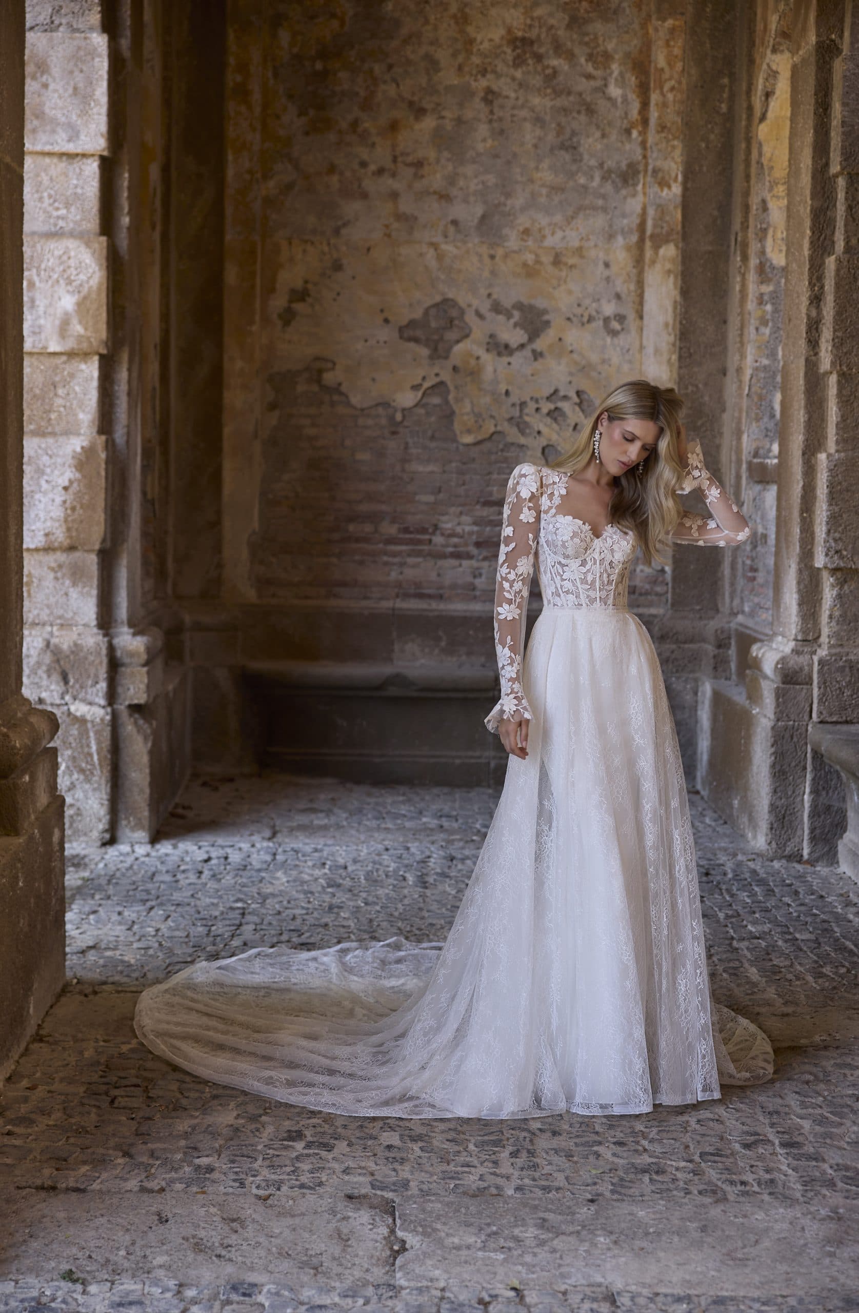 Adrianna 63216 - Veni Infantino wedding dress by Veni Infantino - A sleek, fitted wedding dress featuring a botanical lace...