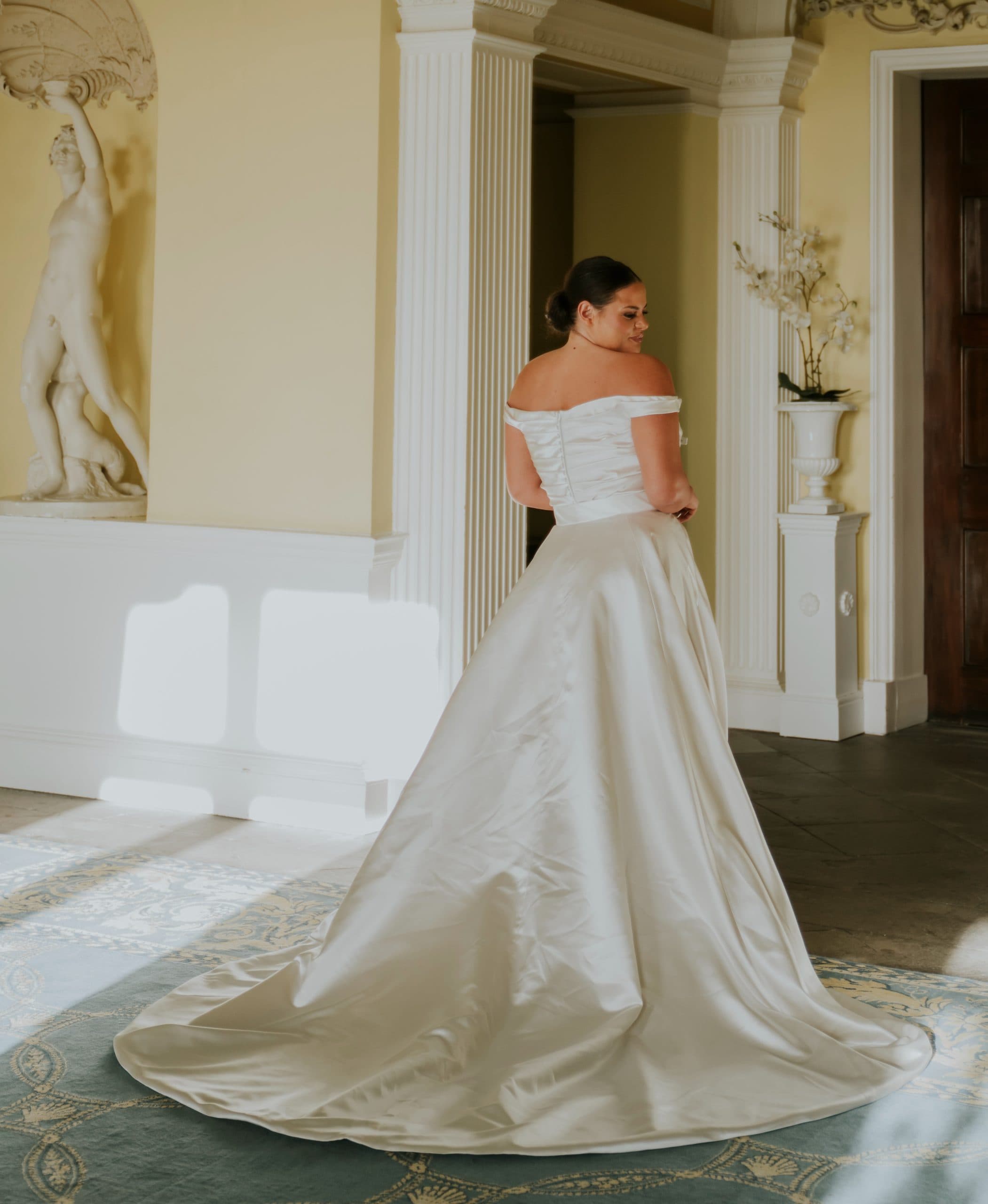 Back view of Zanzibar wedding dress with lace detailing and elegant flowing bridal train