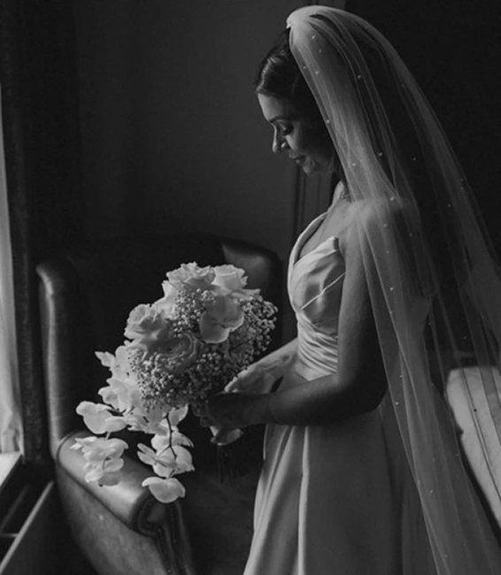 bride Sarah accessories her stunning gown with a pearl veil